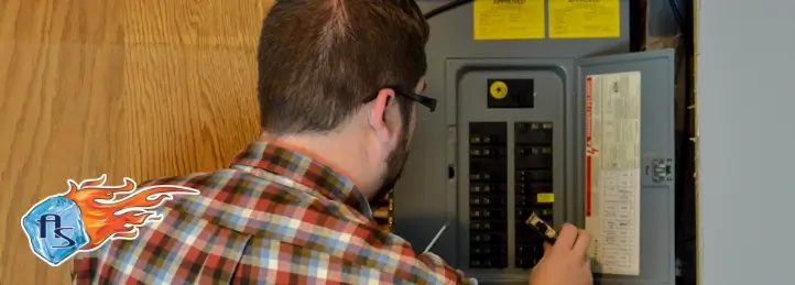 Technician inspecting a home's electrical breaker panel indoors.